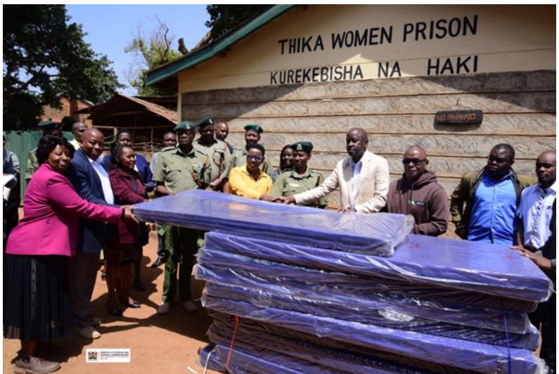 The Principal Secretary Salome Muhia Beacco (in a yellow top) receiving mattress donation from the KCB Foundation Group at Thika Women Prison. Accompanying the PS was Commissioner General of Prisons Brg (Rtd) John Warioba, (PS’s right), Secretary PACS, Ms. Mary Mbau, (in pink) alongside other senior officials from the State Department and KCB Foundation. (Photo Courtesy: Cullen Wasike)
