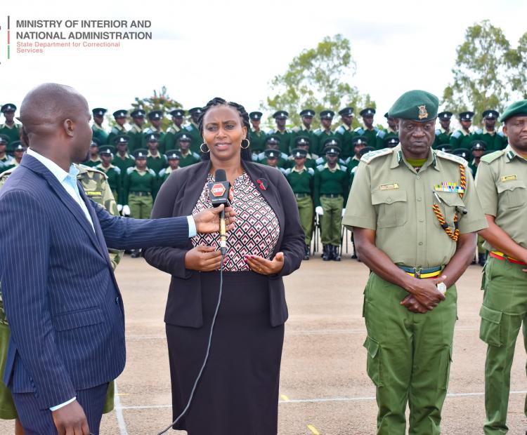PS Correctional Mary Muthoni addressing journalists at the 26th Kenya Prisons Service Cadet Passout Parade at the Prisons Staff Training College, Ruiru. On her left is the Commissioner General of Prisons Brg (Rtd) John Warioba and PSTC Commandant Angus Masoro.