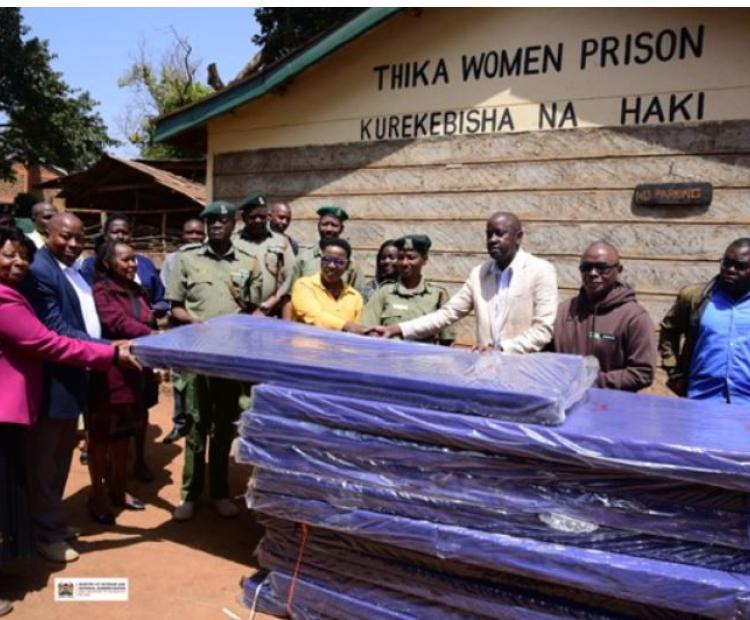 The Principal Secretary Salome Muhia Beacco (in a yellow top) receiving mattress donation from the KCB Foundation Group at Thika Women Prison. Accompanying the PS was Commissioner General of Prisons Brg (Rtd) John Warioba, (PS’s right), Secretary PACS, Ms. Mary Mbau, (in pink) alongside other senior officials from the State Department and KCB Foundation. (Photo Courtesy: Cullen Wasike)